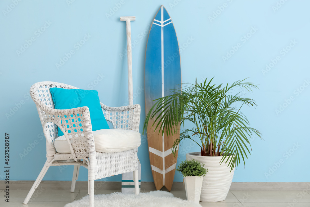 Interior of living room with surfboard, paddle and armchair