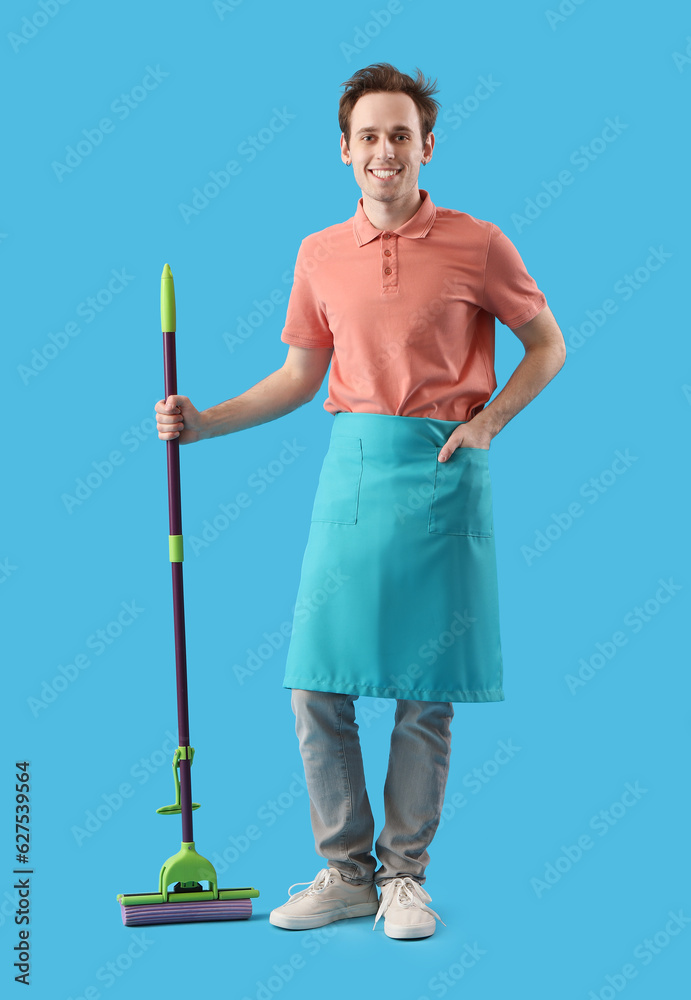 Young man with floor mop on blue background