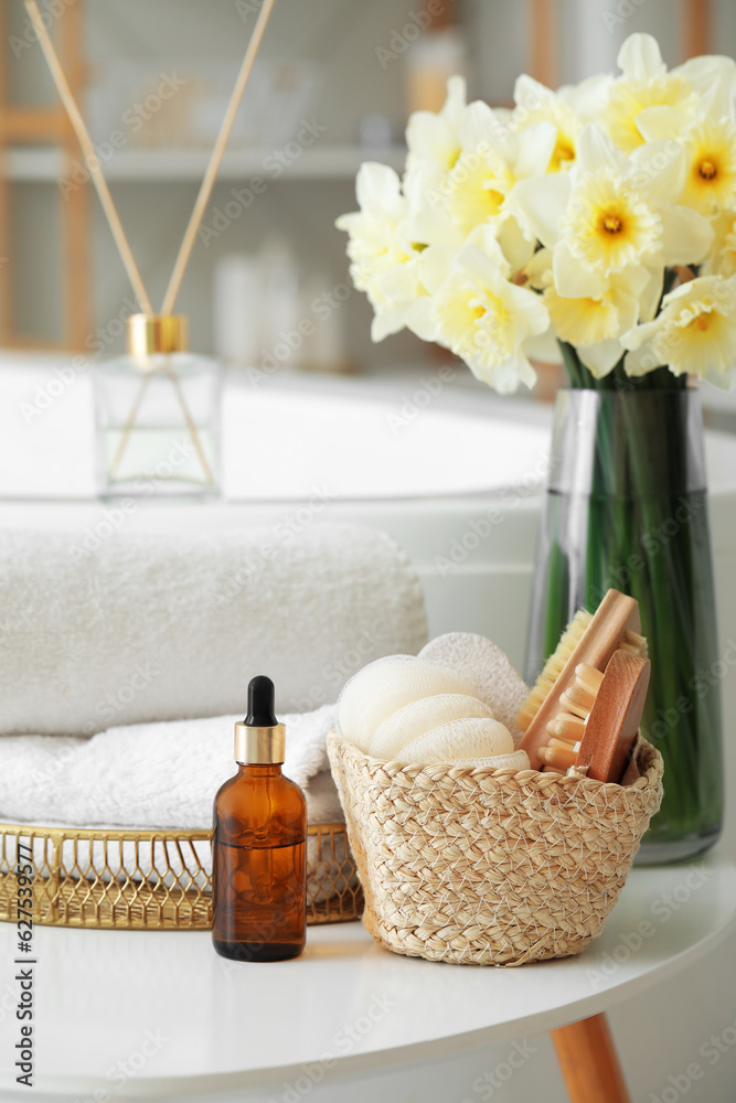 Bathing supplies and bouquet of flowers on table