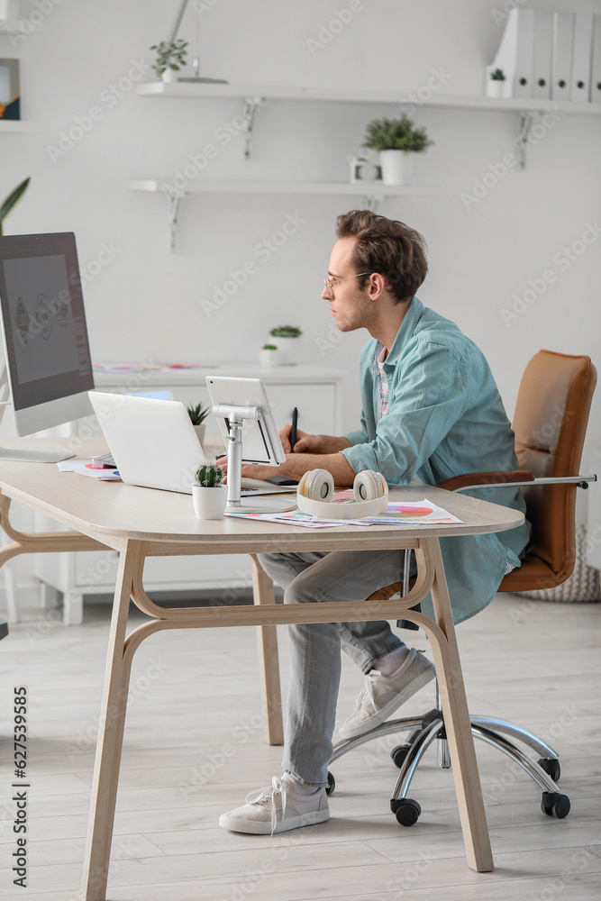 Male graphic designer developing logotype in office