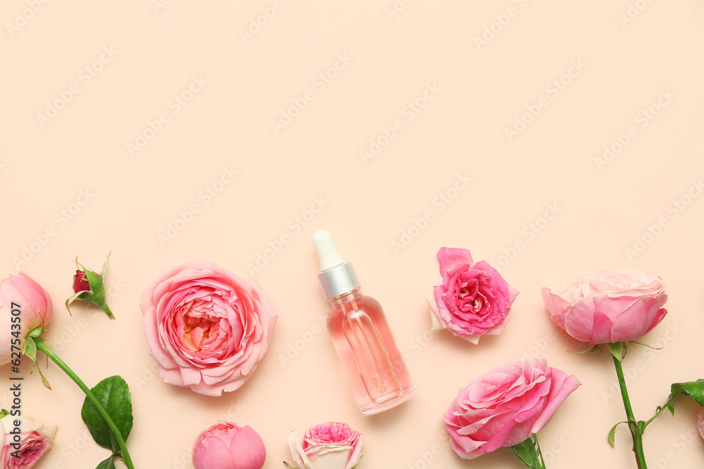 Bottle of cosmetic oil with rose extract and flowers on beige background