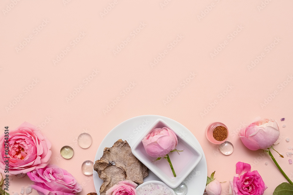 Bottles of cosmetic oil with rose extract and flowers on beige background