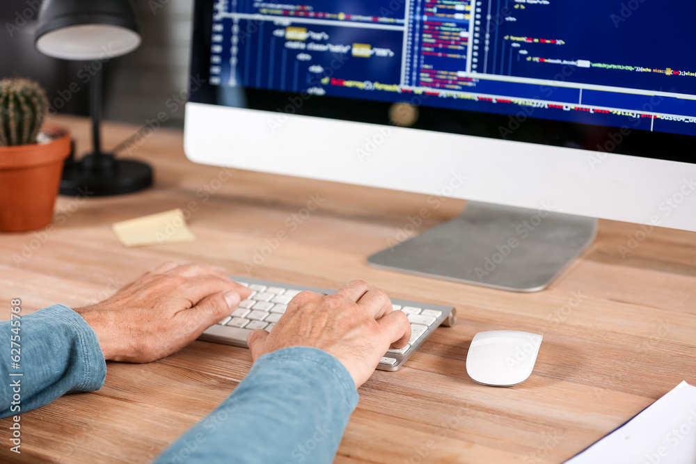 Male programmer working in office, closeup