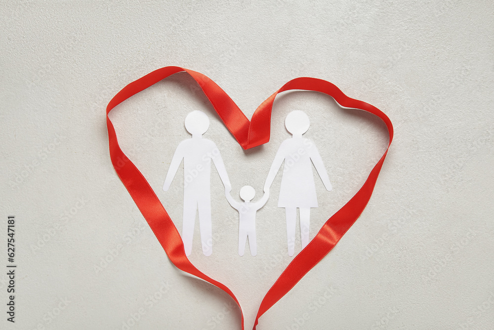 Family figures with heart made of ribbon on white background