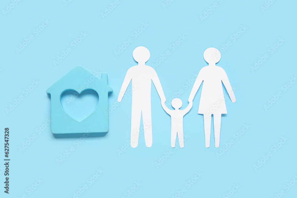 Figures of family with house on blue background