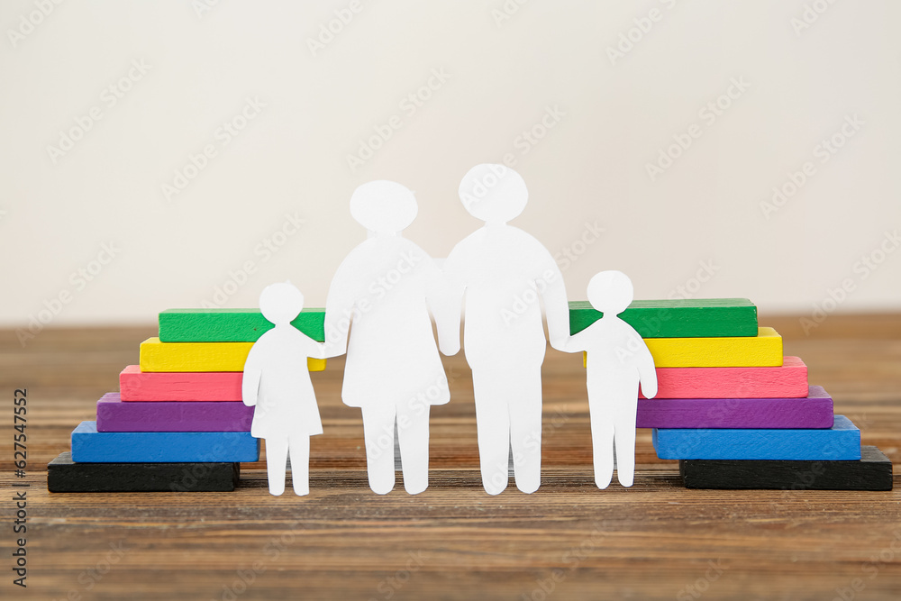 Figures of family and colorful blocks on brown wooden table