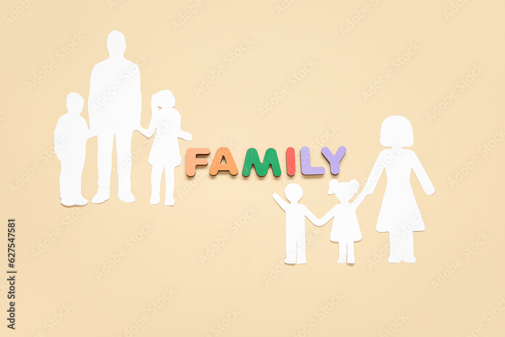 Human figures and word FAMILY made of wooden letters on beige background