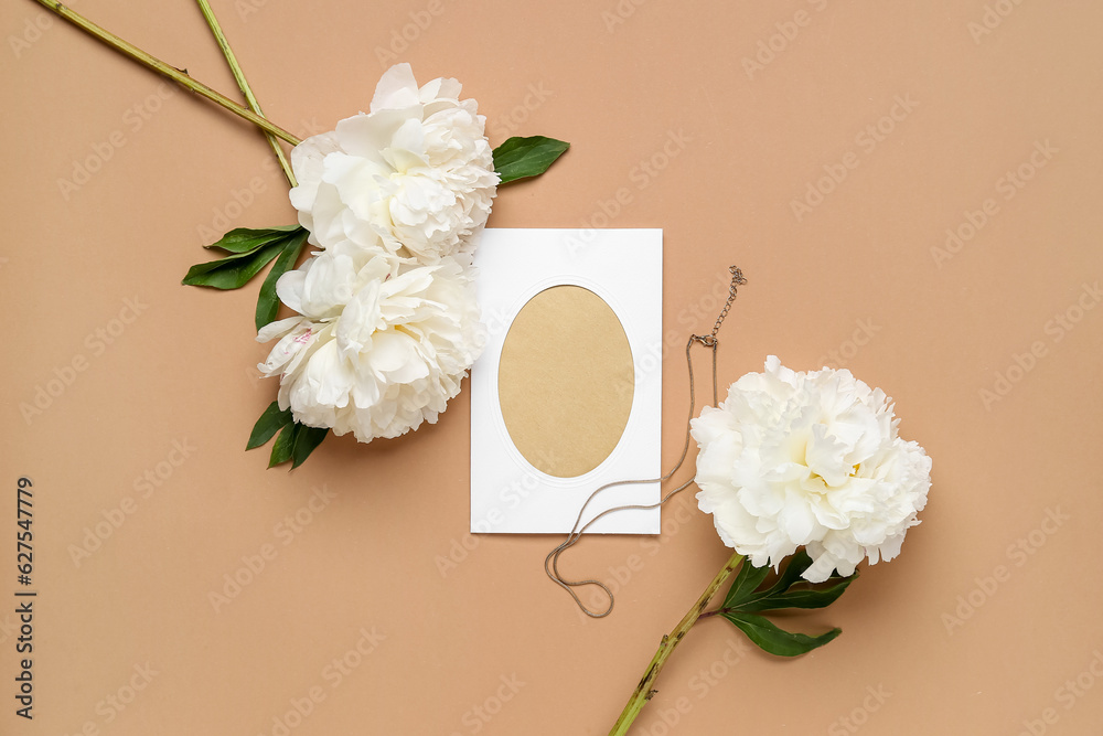 Composition with blank card, necklace and beautiful peony flowers on color background