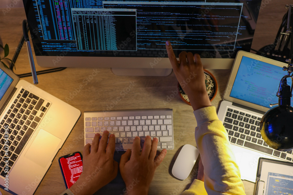 Programmers working in office at night, top view