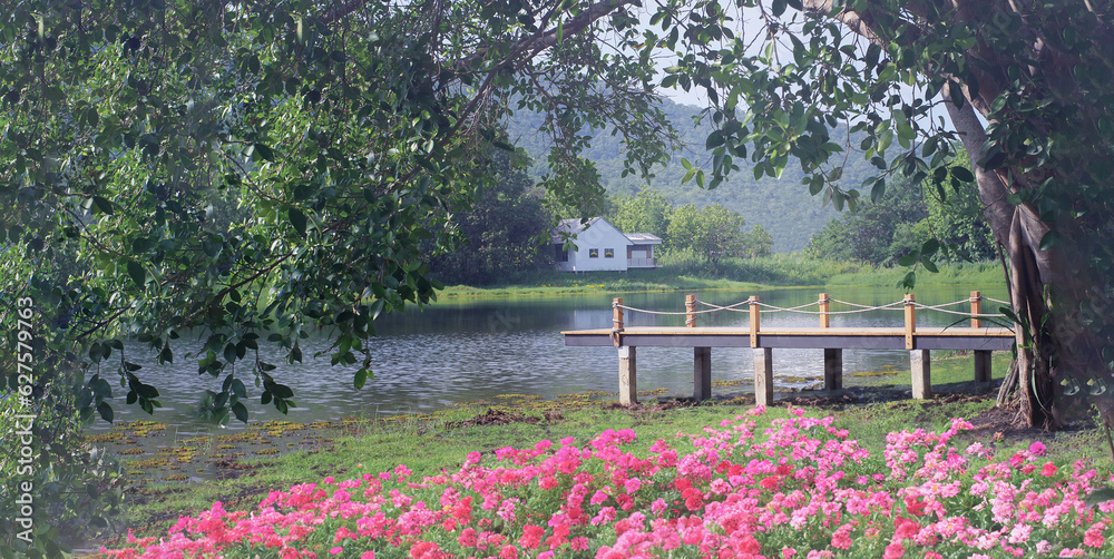 WOODEN BRIDGE IN A COLORFUL GARDEN