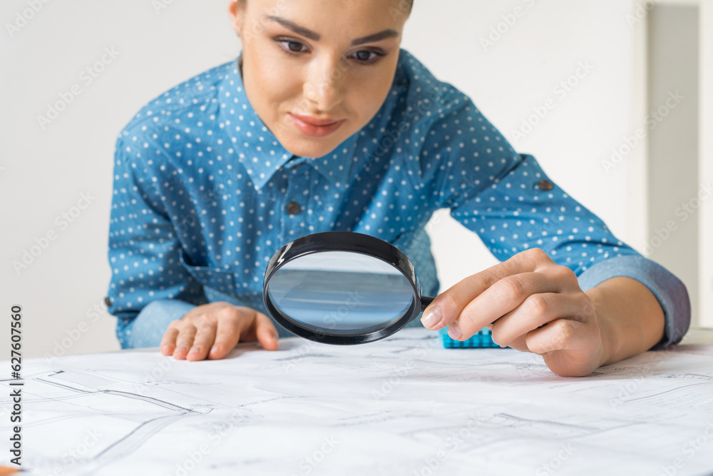 Beautiful woman studying technical drawing