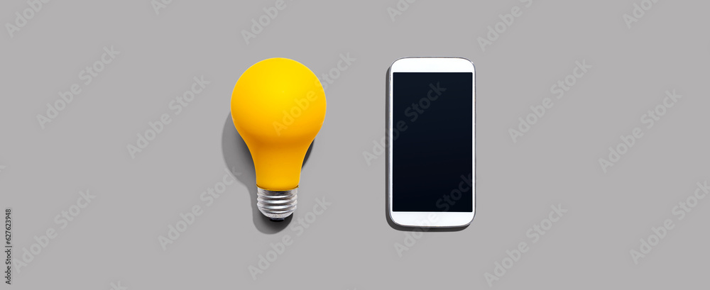 Smartphone with a yellow light bulb from above