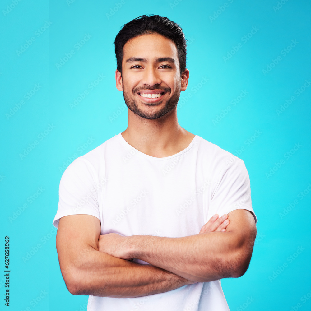 Smile, confident and portrait of Asian man arms crossed with casual fashion isolated in a studio blu