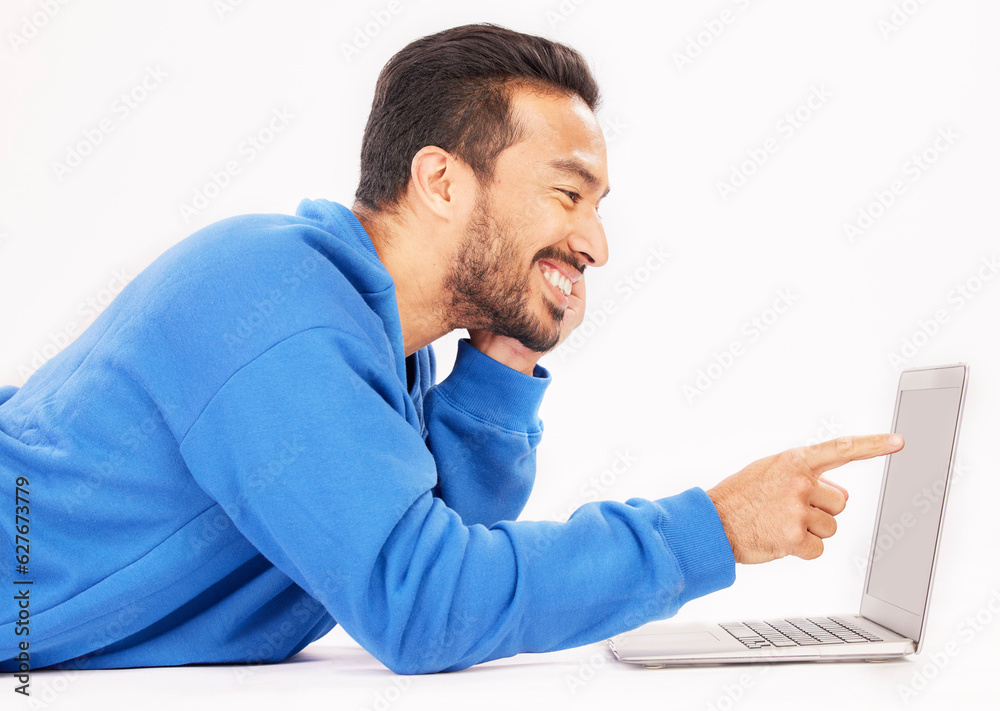 Smile, laptop and man pointing on studio floor isolated on a white background. Computer, happy or pe