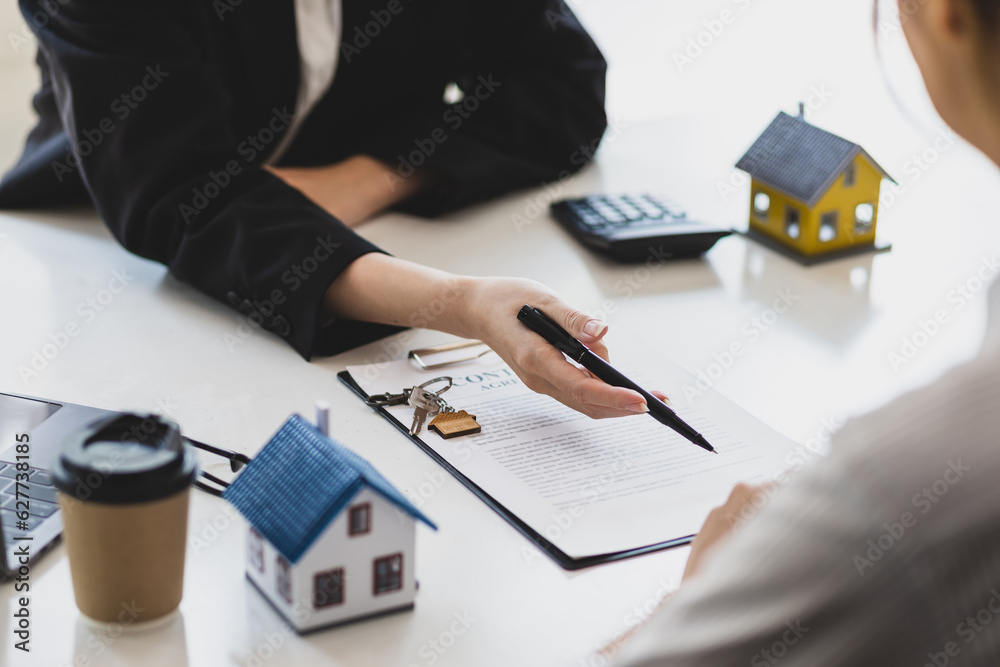 Businesswoman, real estate agent discussing the terms of the house purchase agreement contract docum