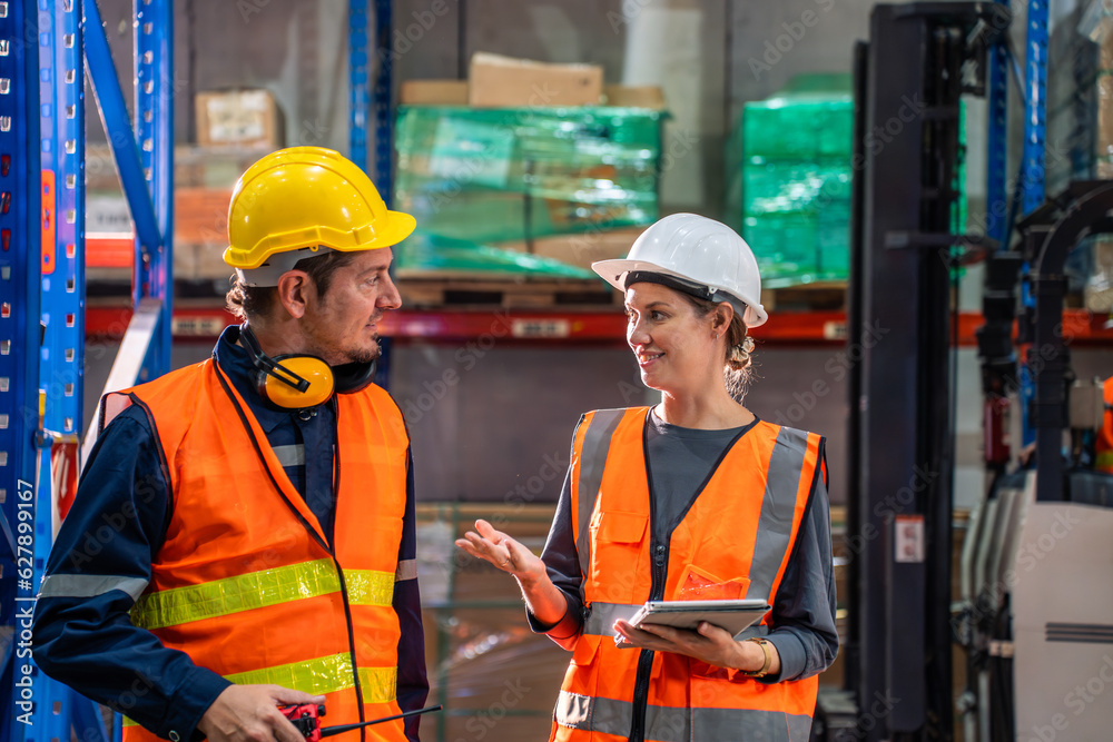 Caucasian man and woman industrial worker work in manufacturing plant. 