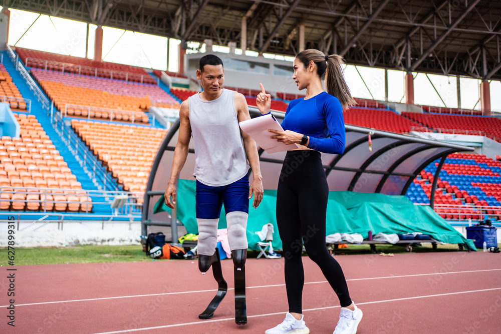 Asian athlete with prosthetic blades and trainer workout in stadium. 