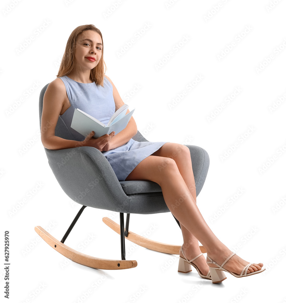 Young woman reading book in armchair on white background