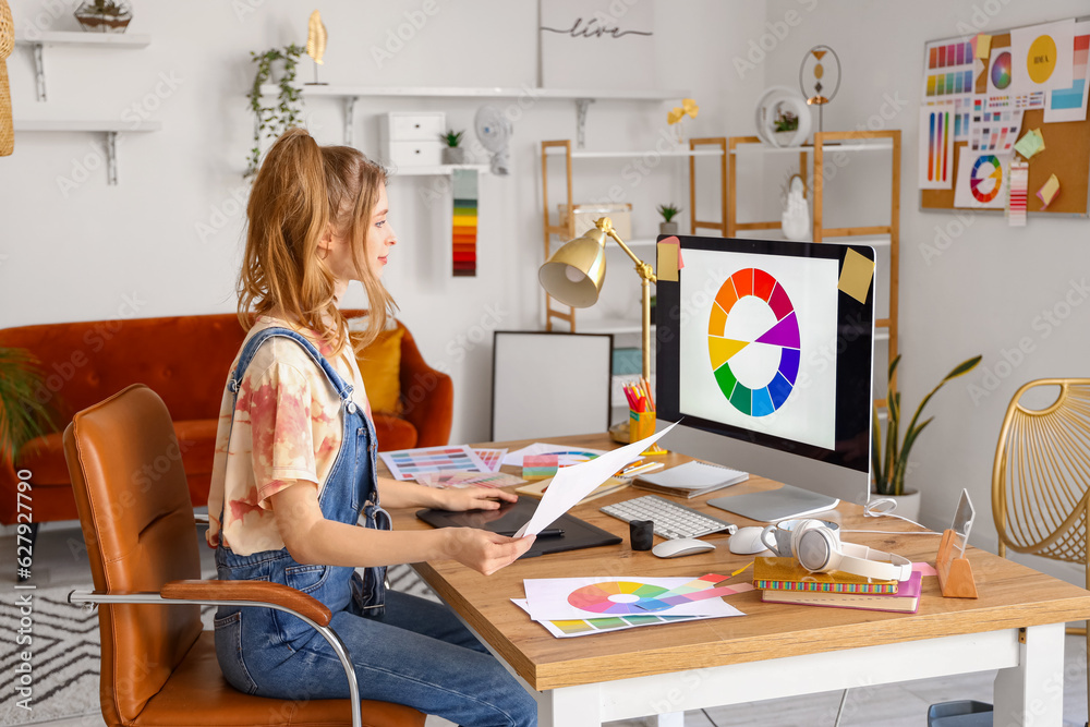 Female graphic designer working at table in office