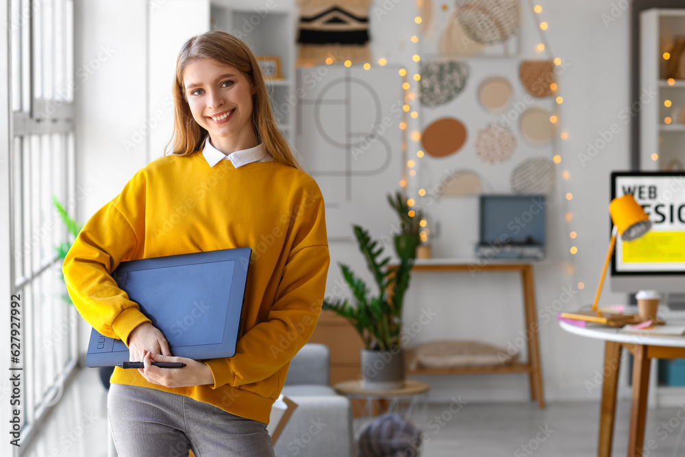 Female graphic designer with tablet in office