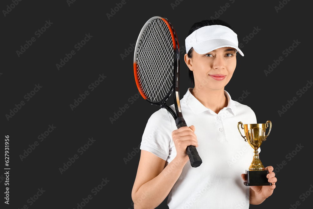 Female badminton player with gold cup on black background