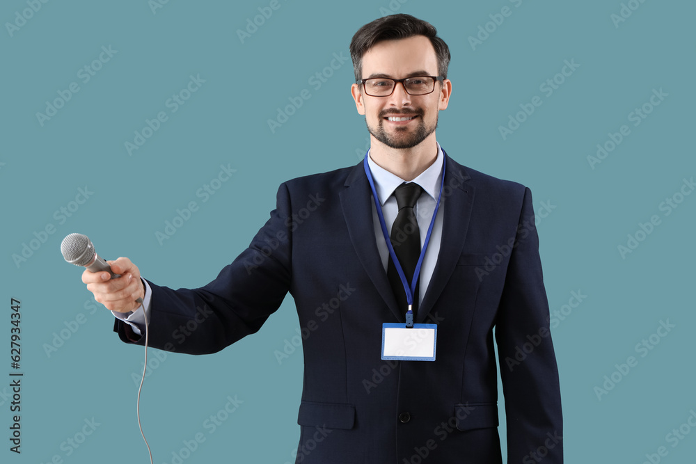 Male journalist with microphone on blue background