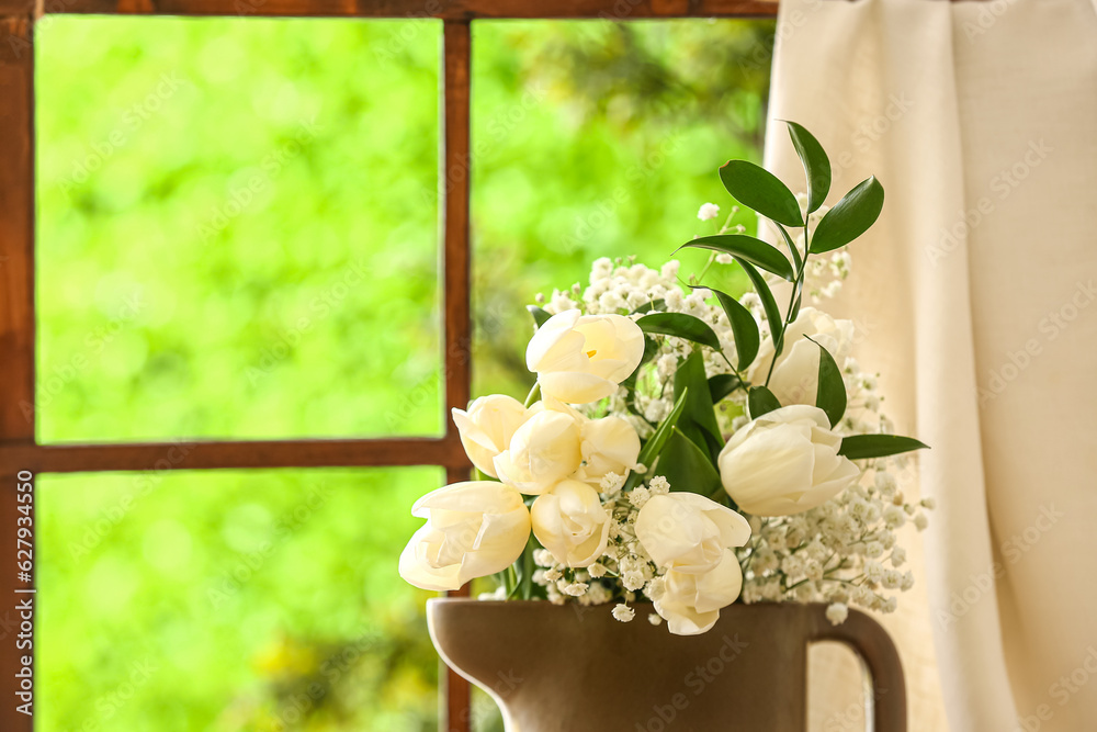 Vase with beautiful tulip and gypsophila flowers near window