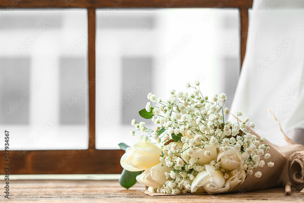 Bouquet of blooming tulip flowers on windowsill