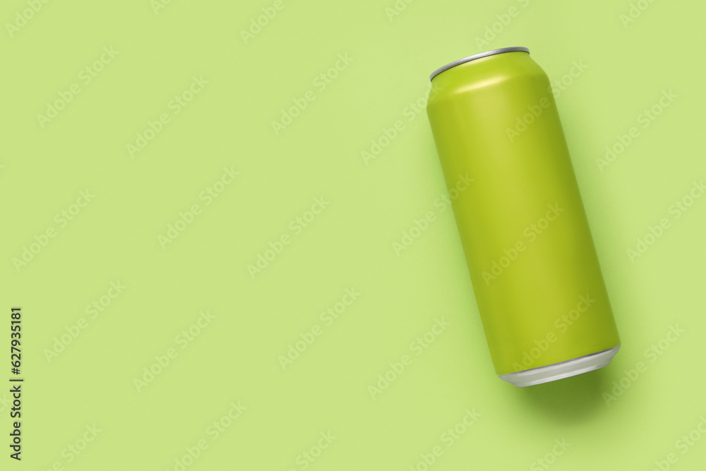 Can of soda on green background