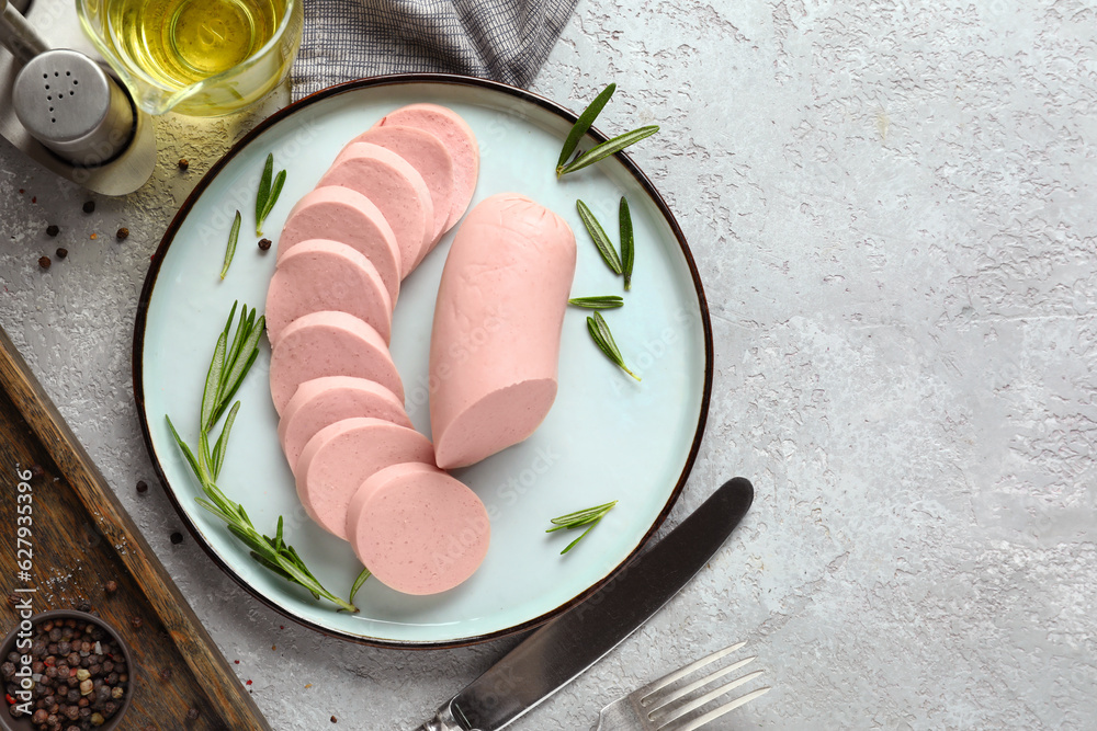 Plate with tasty boiled sausage on light background