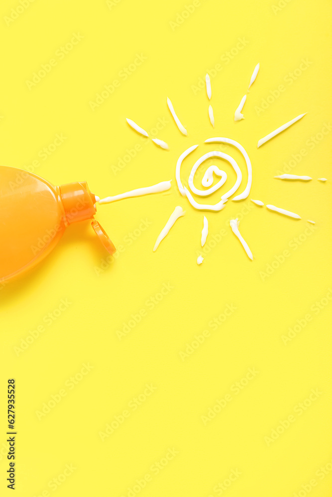 Drawing of sun made with sunscreen cream on yellow background