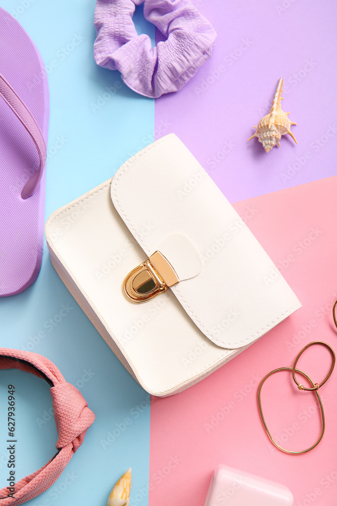 Stylish bag and different accessories on colorful background