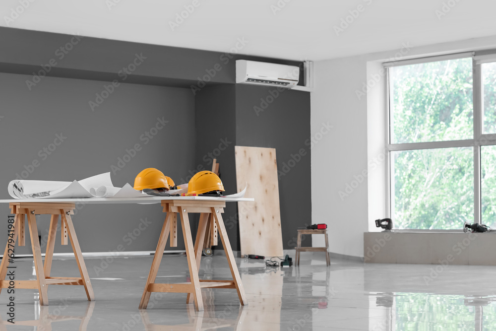 Table with builders equipment in room