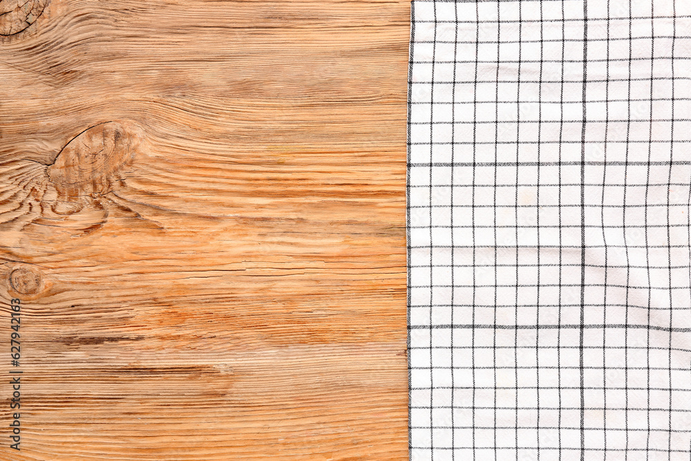 Light checkered napkin on wooden background