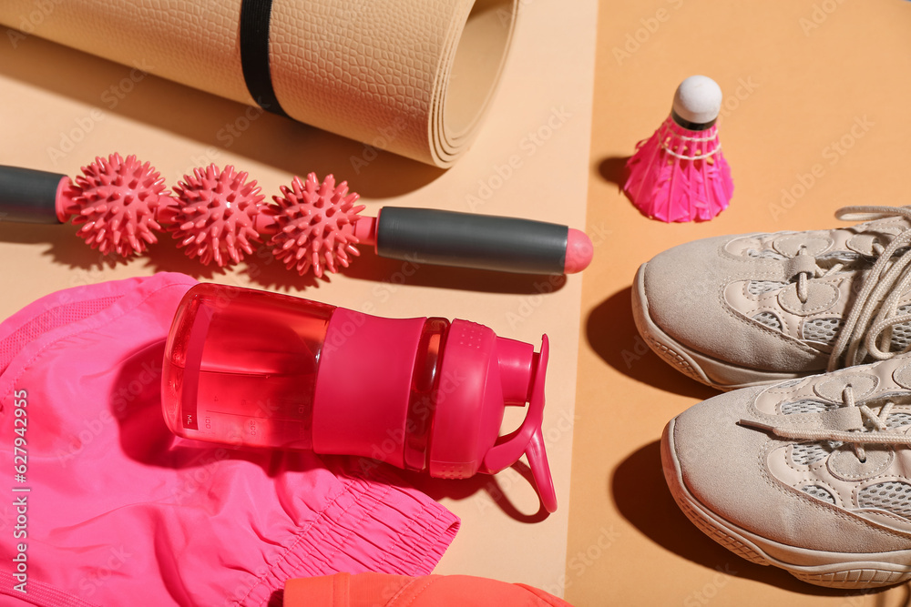 Set of sports equipment, clothes and bottle of water on color background, closeup