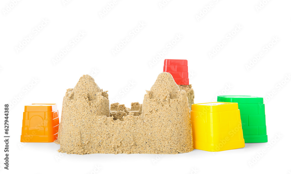 Castle made of sand with beach toys for children isolated on white background