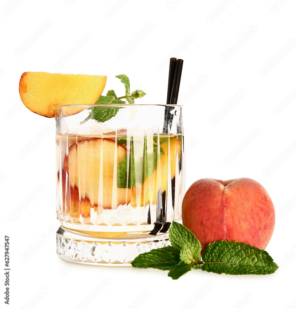 Glass of fresh peach lemonade with mint on white background