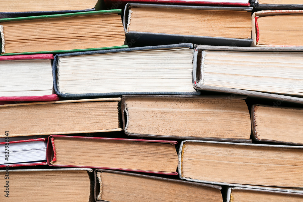 Many stacked books as background, closeup