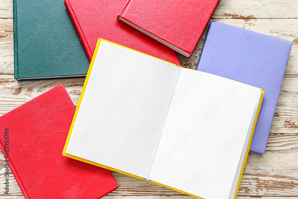 Open book with blank pages on white wooden table