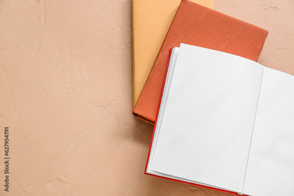 Open book with blank pages on beige background