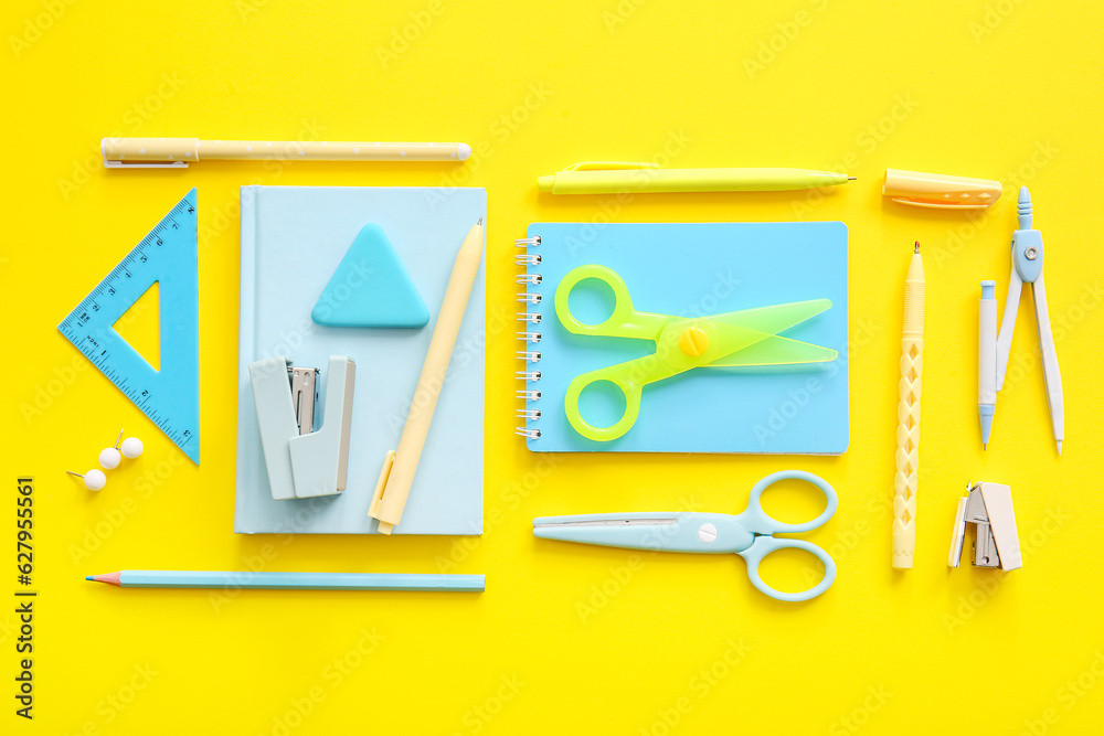 Different school stationery and notebooks on yellow background