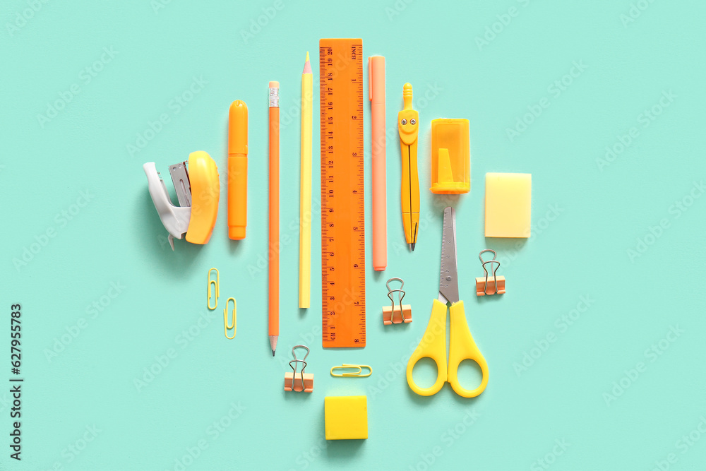 Different school stationery on turquoise background