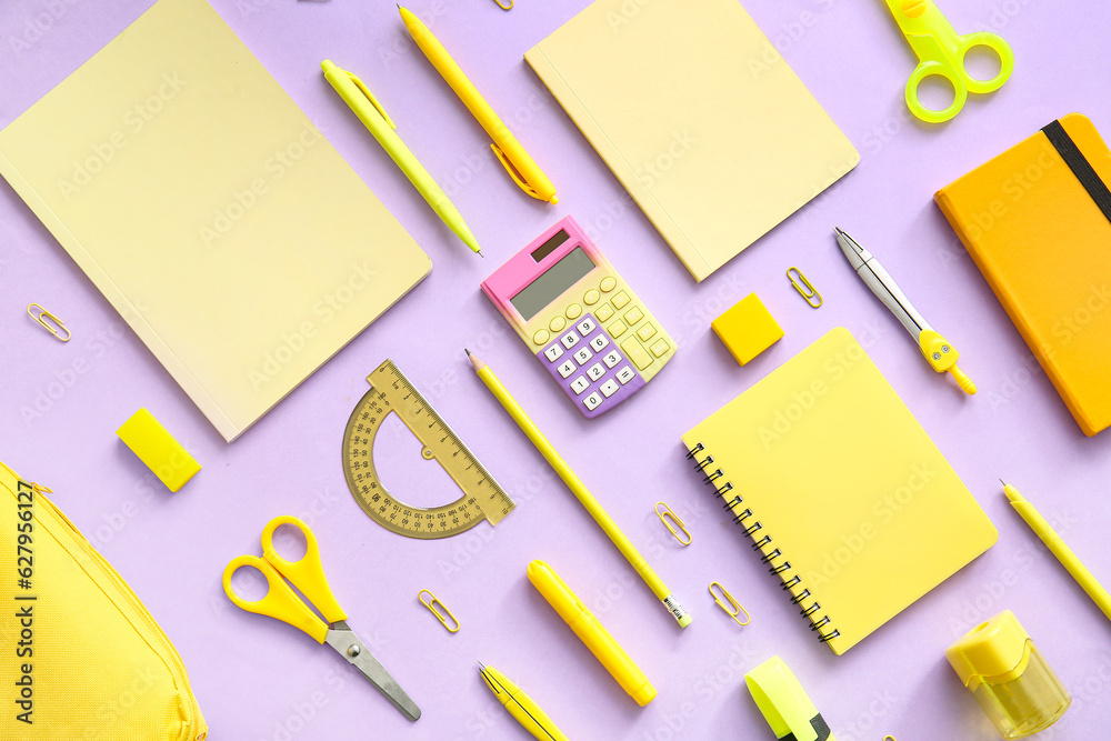 Different school stationery and notebooks on purple background