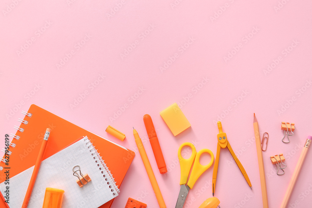 Different school stationery and notebook on pink background