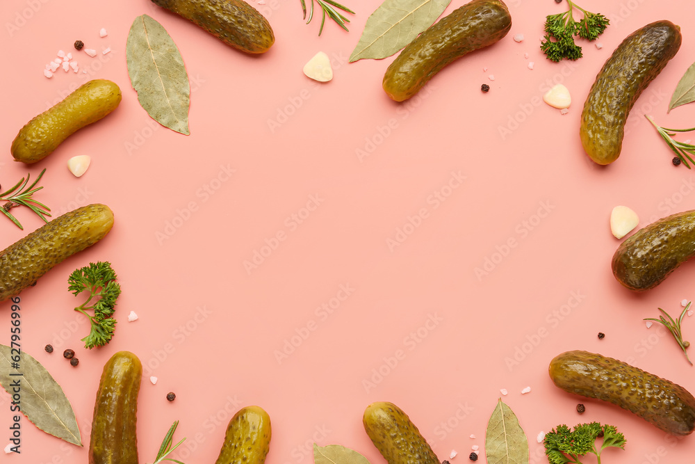 Frame made of pickled cucumbers and different spices on red background