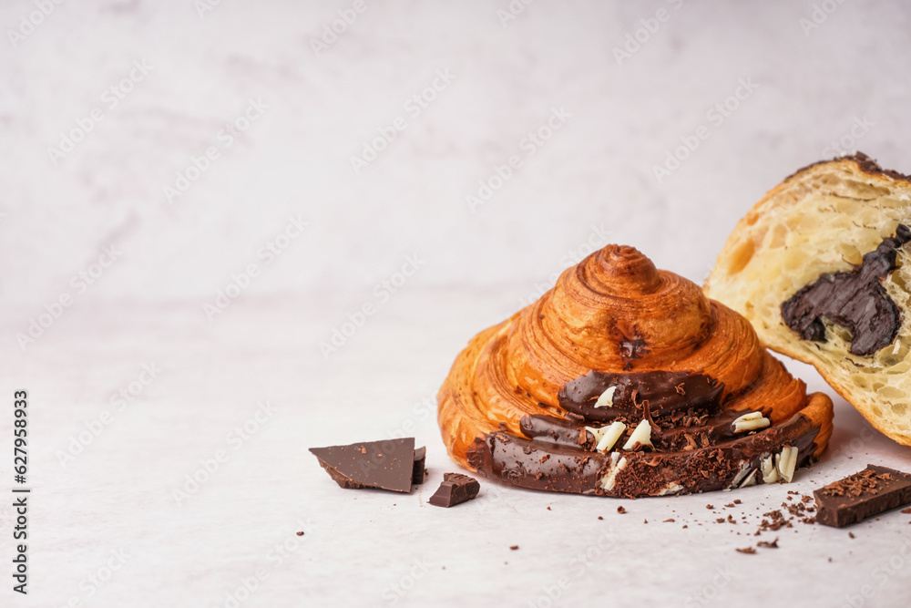 Sweet croissant with chocolate on white background