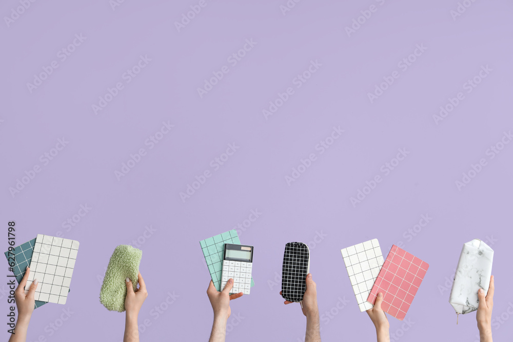 Hands with school supplies on lilac background