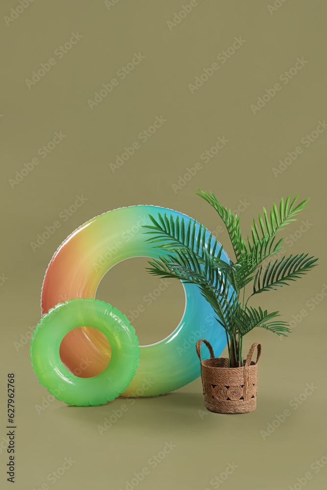 Swim rings with palm tree on green background