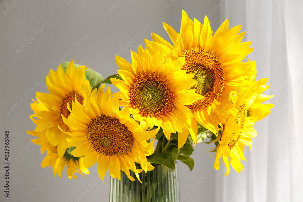 Vase with beautiful sunflowers in room, closeup