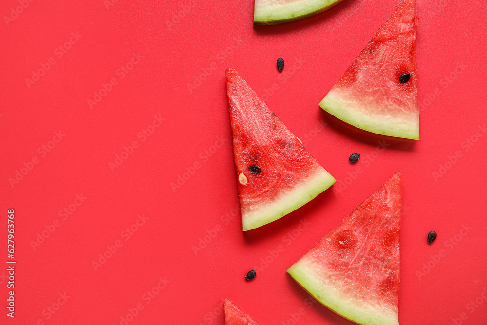 Composition with pieces of ripe watermelon on red background